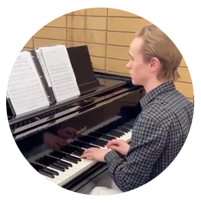 Josh plays at a practice piano in the Fine Arts Center